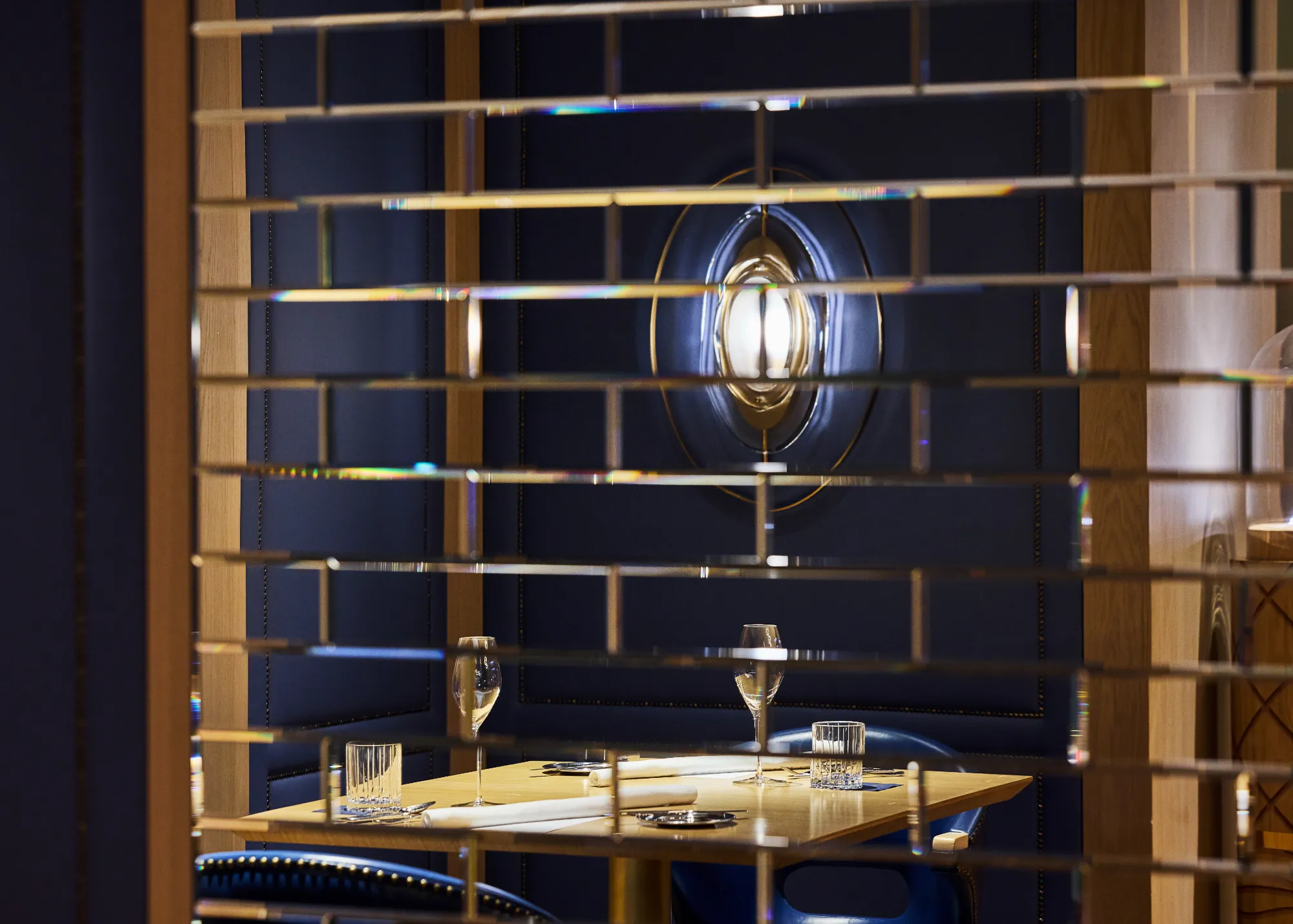 The Tambourine Room dining room, brass screens and blue velvet